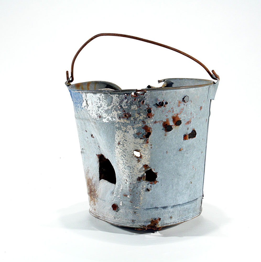 a metal bucket rusted, slightly damaged